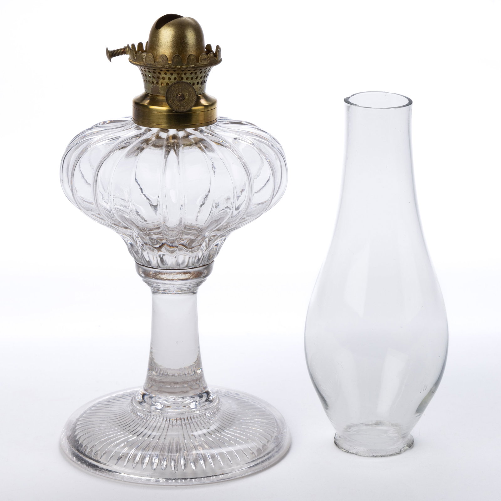 CITY MANUFACTURING CO. NO. 0 LIP BURNER AND CHIMNEY SETUP: CITY MANUFACTURING CO. NO. 0 LIP BURNER AND CHIMNEY SETUP, brass burner, thumbwheel marked "CITY M. F. G. CO. / PAT'D MAR. 3 / 1863", colorless lip chimney. Fitted on a colorless Melon Ribbed kerosene