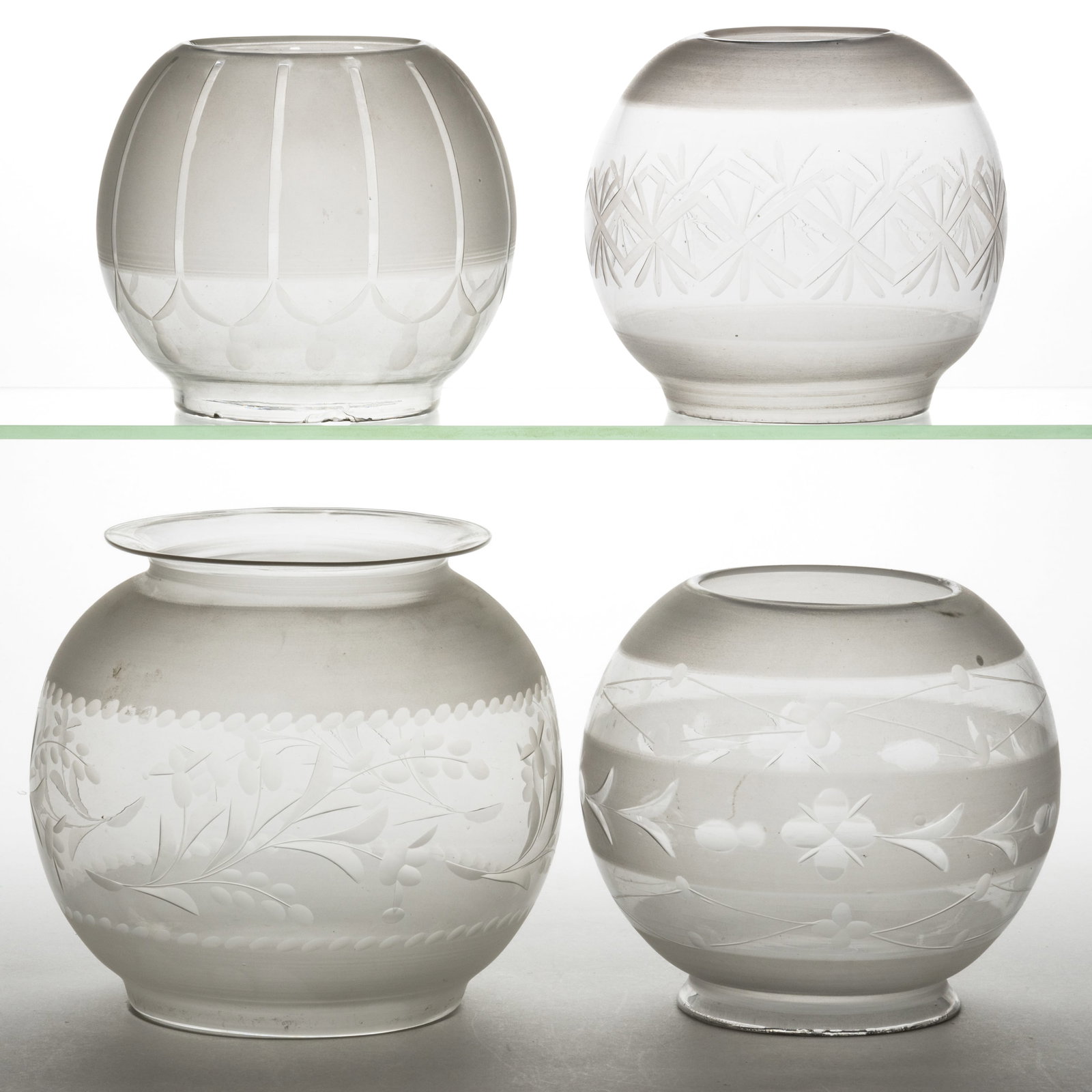 ASSORTED BLOWN CUT AND ENGRAVED LAMP SHADES, LOT OF FOUR: ASSORTED BLOWN CUT AND ENGRAVED LAMP SHADES, LOT OF FIVE, colorless with frosted finish, each of globular form with two examples having various stylized foliage and berry patterns, including one examp