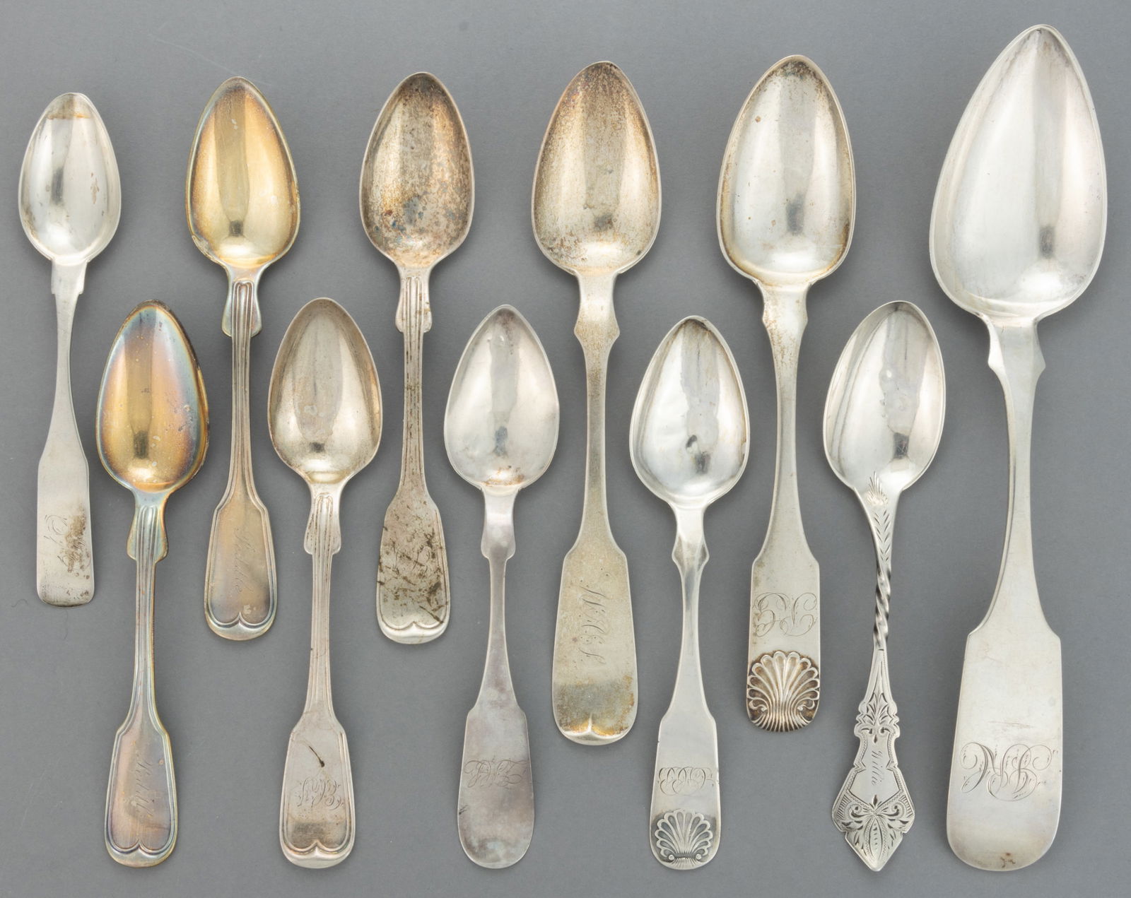 PENNSYLVANIA AND OTHER AMERICAN COIN SILVER SPOONS, LOT OF 11: PENNSYLVANIA AND OTHER AMERICAN COIN SILVER SPOONS, LOT OF 11, each piece having a personalized engraving to handle; comprising a teaspoon retailed by James D. Anderson & Co. of New Orleans, LA (a