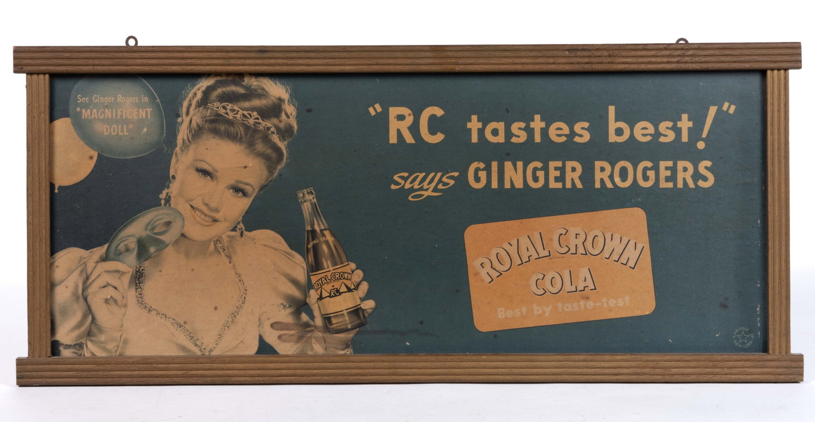ROYAL CROWN COLA CARDBOARD ADVERTISING SIGN FEATURING GINGER ROGERS: ROYAL CROWN COLA CARDBOARD ADVERTISING SIGN FEATURING GINGER ROGERS, lithography on cardboard, featuring actress Ginger Rogers on the left side advertising her movie "Magnificent Doll", the 