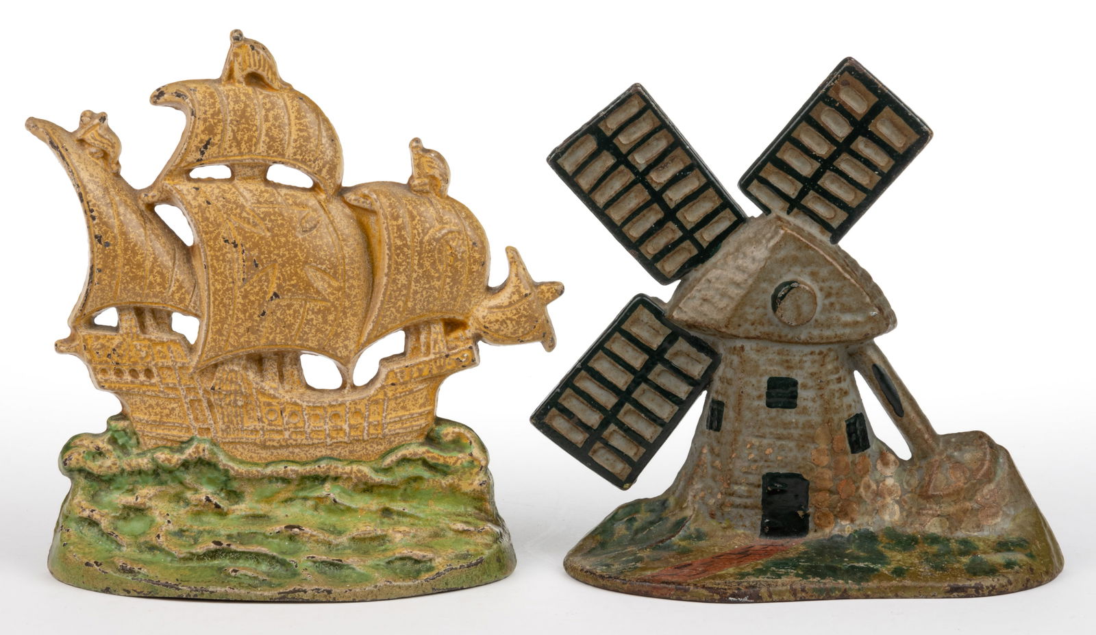 ASSORTED CAST-IRON FIGURAL DOORSTOPS, LOT OF TWO: ASSORTED CAST-IRON FIGURAL DOORSTOPS, LOT OF TWO, each with a flat-back form, comprising a Creations Co. Galleon example with original brown/tan and green paint; and a patented windmill with original