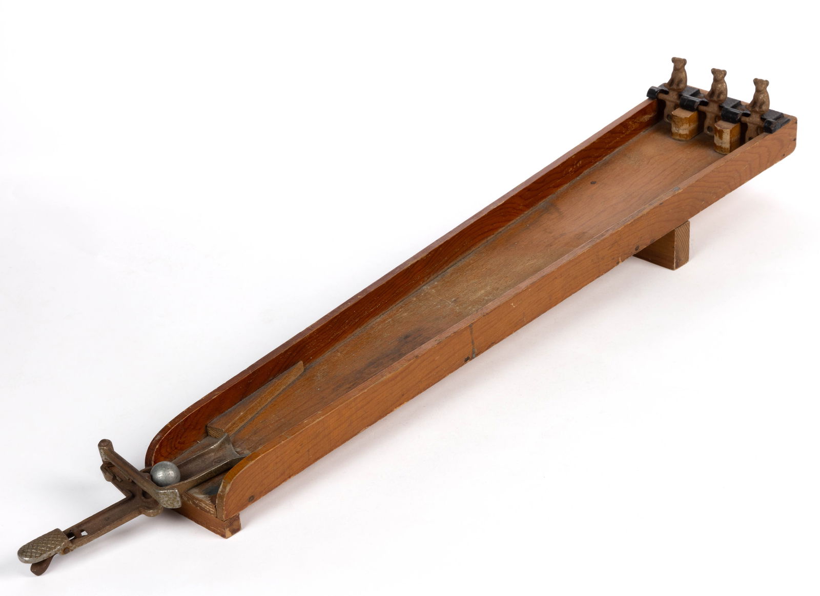 RARE ARCADE RIFLE RANGE CAST-IRON AND WOOD SHOOTING TOY: RARE ARCADE RIFLE RANGE CAST-IRON AND WOOD SHOOTING TOY, pine base with a cast-iron spring-loaded gun at the base and three sitting dogs which toggle down as they're hit. Retains the original &quo