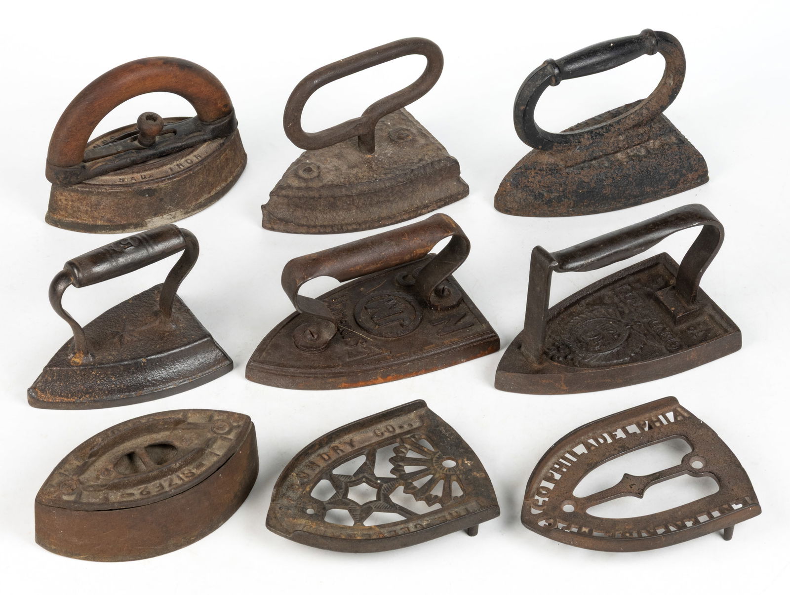 ASSORTED CAST-IRON SAD / FLAT IRONS AND TRIVETS, LOT OF NINE (1 of 2)