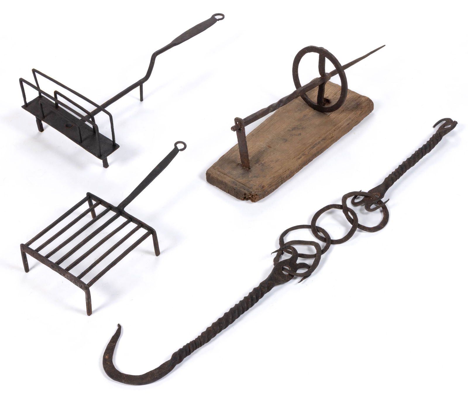 ASSORTED WROUGHT-IRON HEARTH / KITCHEN DOMESTIC ARTICLES, LOT OF FOUR: ASSORTED WROUGHT-IRON HEARTH / KITCHEN DOMESTIC ARTICLES, LOT OF FOUR, comprising a rotating toaster, a square-form trivet with grid plate, a partial possible rotisserie with mounting brace attac