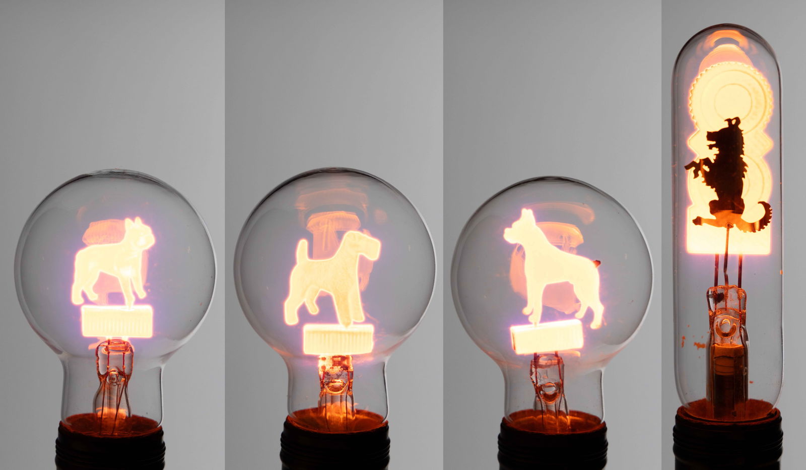 VINTAGE AEROLUX-STYLE DOG FIGURAL FILAMENT GAS DISCHARGE / NEON GLOW LIGHT BULBS, LOT OF FOUR (1 of 2)