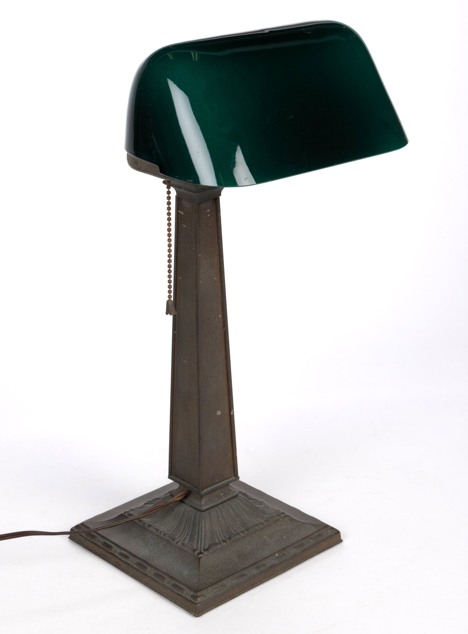 EMERALITE CASED GLASS AND BRASS DESK LAMP: EMERALITE CASED GLASS AND BRASS DESK LAMP, green to opaque white cased glass shade, raised on a single-arm support with applied plaque reading “EMERALITE DESK LAMP”, terminating in a squar