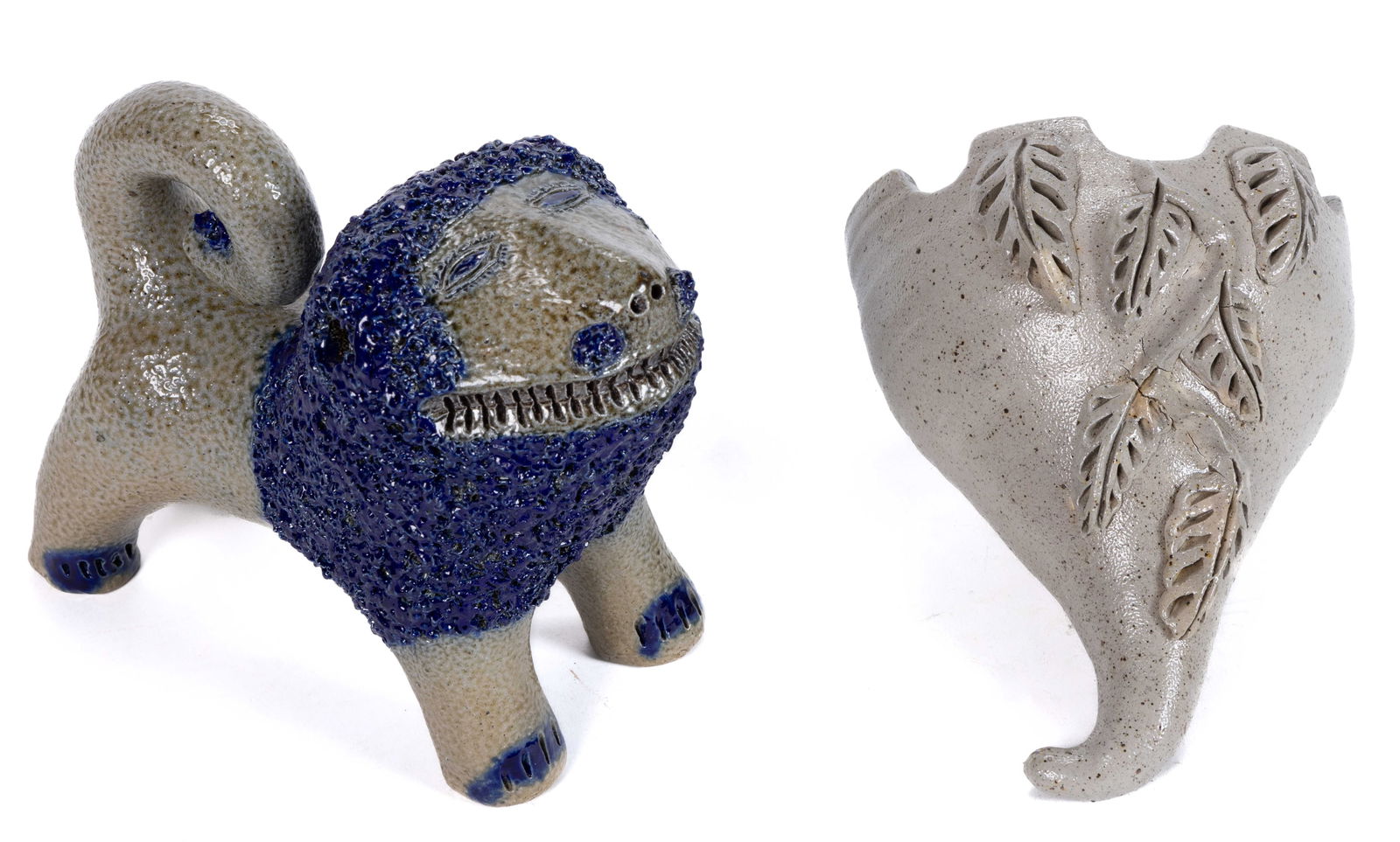 SIGNED BILLY RAY HUSSEY, NORTH CAROLINA STONEWARE ARTICLES, LOT OF TWO: SIGNED BILLY RAY HUSSEY, NORTH CAROLINA STONEWARE ARTICLES, LOT OF TWO, comprising a standing figural grinning lion with tail curled onto back and two pierced nostrils, having royal blue-accented