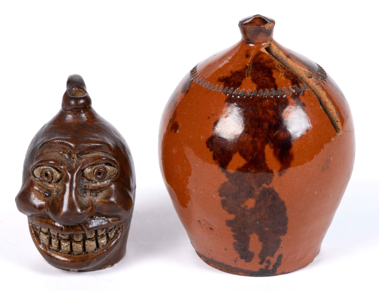 AMERICAN EARTHENWARE / REDWARE DIMINUTIVE / MINIATURE ARTICLES, LOT OF TWO: AMERICAN EARTHENWARE / REDWARE DIMINUTIVE / MINIATURE ARTICLES, LOT OF TWO, comprising a 2 3/8" HOA hand-modeled face jug with inset ceramic eyes, applied brow ridge, nose, and open grinning