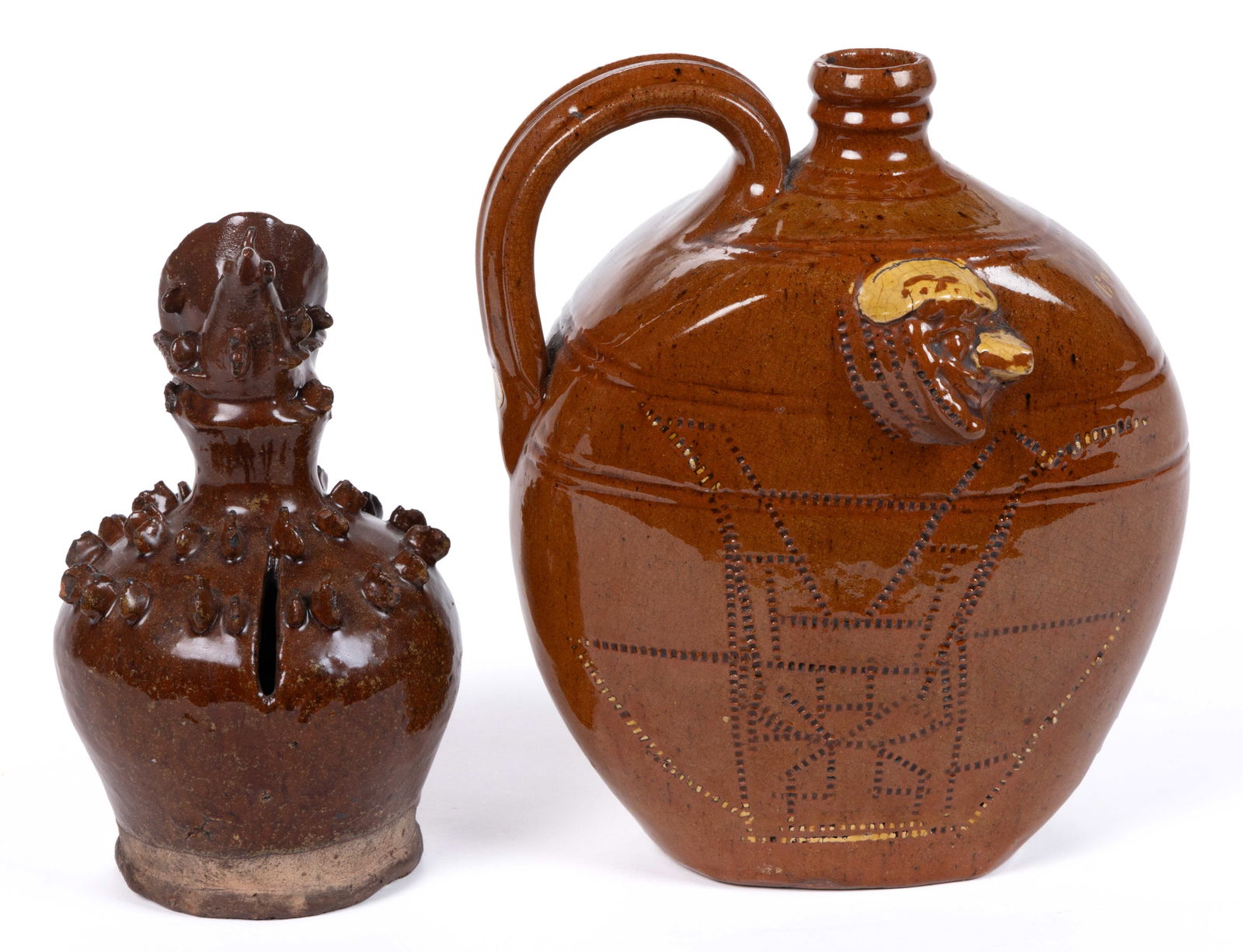 BRITISH EARTHENWARE / REDWARE ARTICLES, LOT OF TWO: BRITISH EARTHENWARE / REDWARE ARTICLES, LOT OF TWO, lead-glazed, comprising a money box/bank featuring a bird with fanned-tail perched on a globular-form base having two rows of applied fin-like