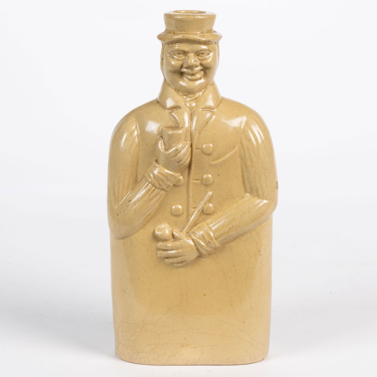 AMERICAN YELLOWWARE POTTERY FIGURAL WHISKEY FLASK / BOTTLE: AMERICAN YELLOWWARE POTTERY FIGURAL WHISKEY FLASK / BOTTLE, translucent lead glaze over yellowware/buff earthenware clay, molded oval-shaped body in the form of a jolly man wearing a hat and