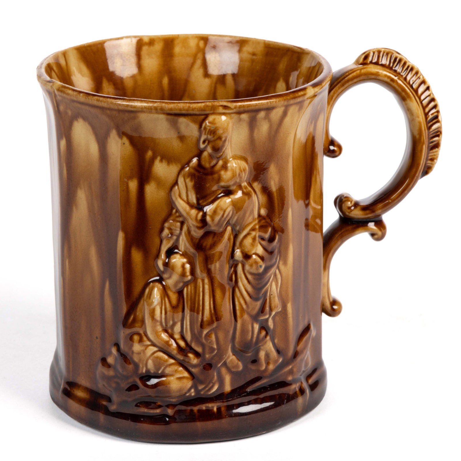 E. & W. BENNETT, BALTIMORE, MARYLAND ATTRIBUTED "NAOMI & DAUGHTERS" ROCKINGHAM-GLAZED POTTERY MUG: E. & W. BENNETT, BALTIMORE, MARYLAND ATTRIBUTED "NAOMI & DAUGHTERS" ROCKINGHAM-GLAZED POTTERY MUG, mottled honey-brown glaze, cylindrical ten-paneled body with both sides having reli