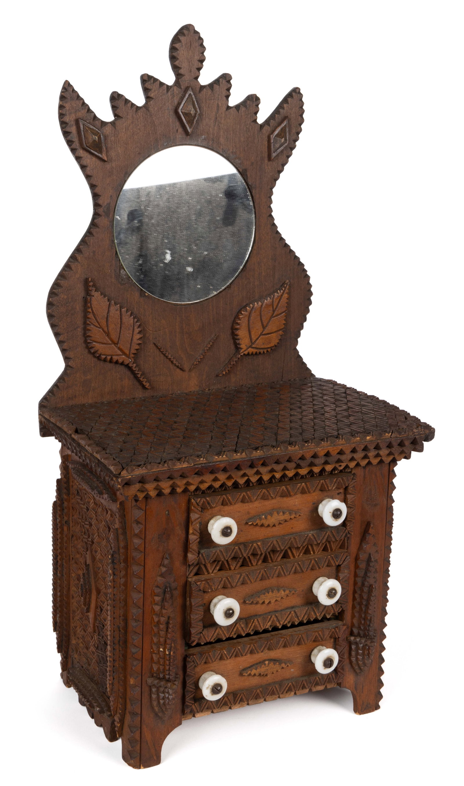 AMERICAN FOLK / TRAMP ART MINIATURE CHEST OF DRAWERS / DRESSER: AMERICAN FOLK / TRAMP ART MINIATURE CHEST OF DRAWERS / DRESSER, of finely executed form with elaborately notch-carved stacked designs with sawtooth edge profiles, the shaped back featur