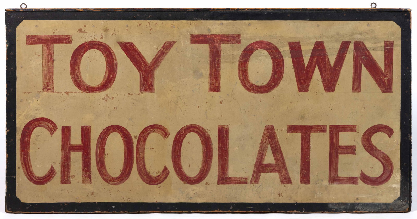 WINCHENDON, MASSACHUSETTS FOLK ART PAINTED CANDY STORE TRADE SIGN: WINCHENDON, MASSACHUSETTS FOLK ART PAINTED CANDY STORE TRADE SIGN, marked "TOY TOWN / CHOCOLATES", oil on board applied to wooden frame, the double-sided rectangular form with red lettering 