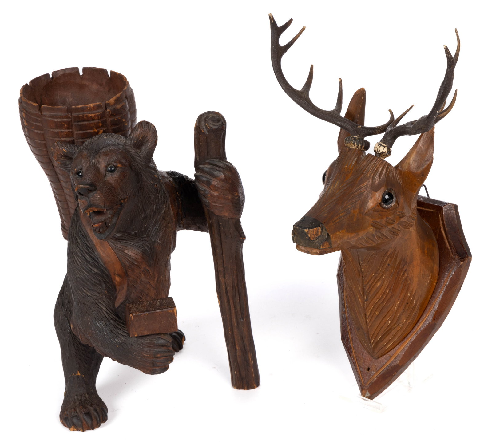 GERMAN / SWISS BLACK FOREST CARVED FIGURES, LOT OF TWO: GERMAN / SWISS BLACK FOREST CARVED FIGURES, LOT OF TWO, comprising a bear with a basket on his back, and a staff and hammer in his hands; and a deer mounted to a shield-form plaque with natural a
