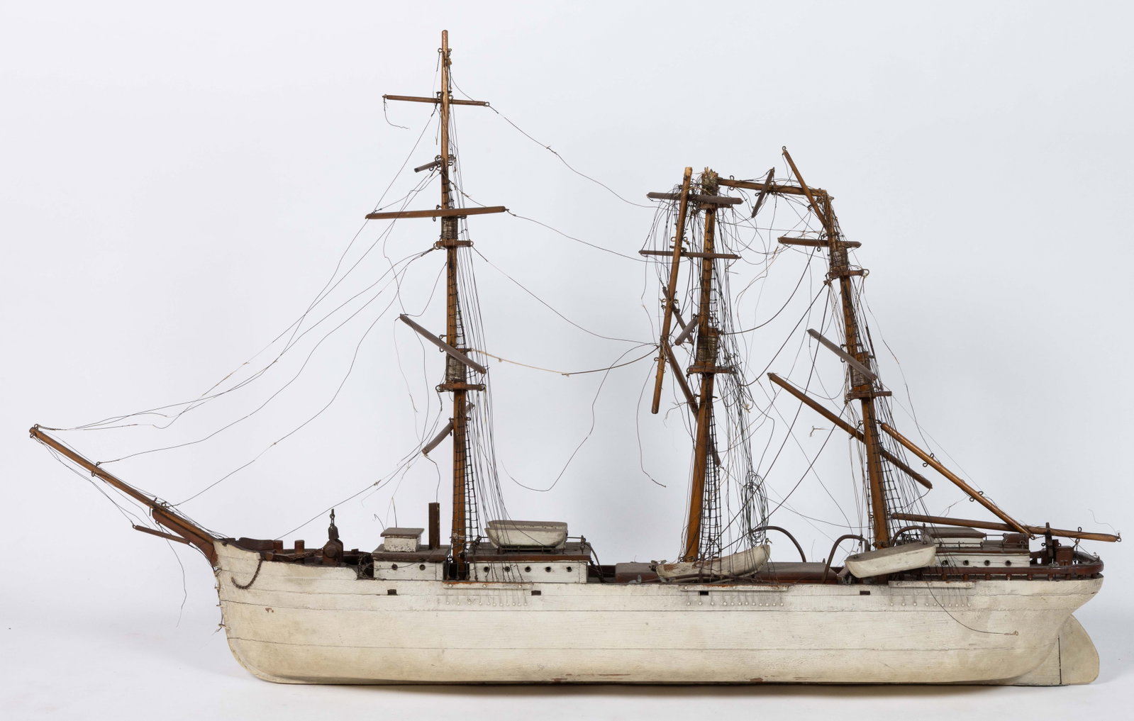 AMERICAN FOLK ART SHIP MODEL / POND BOAT: AMERICAN FOLK ART SHIP MODEL / POND BOAT, featuring three masts, many assorted deckhouses, and a number of lifeboats. Retains its original paint-decorated surface and many of its original components. 