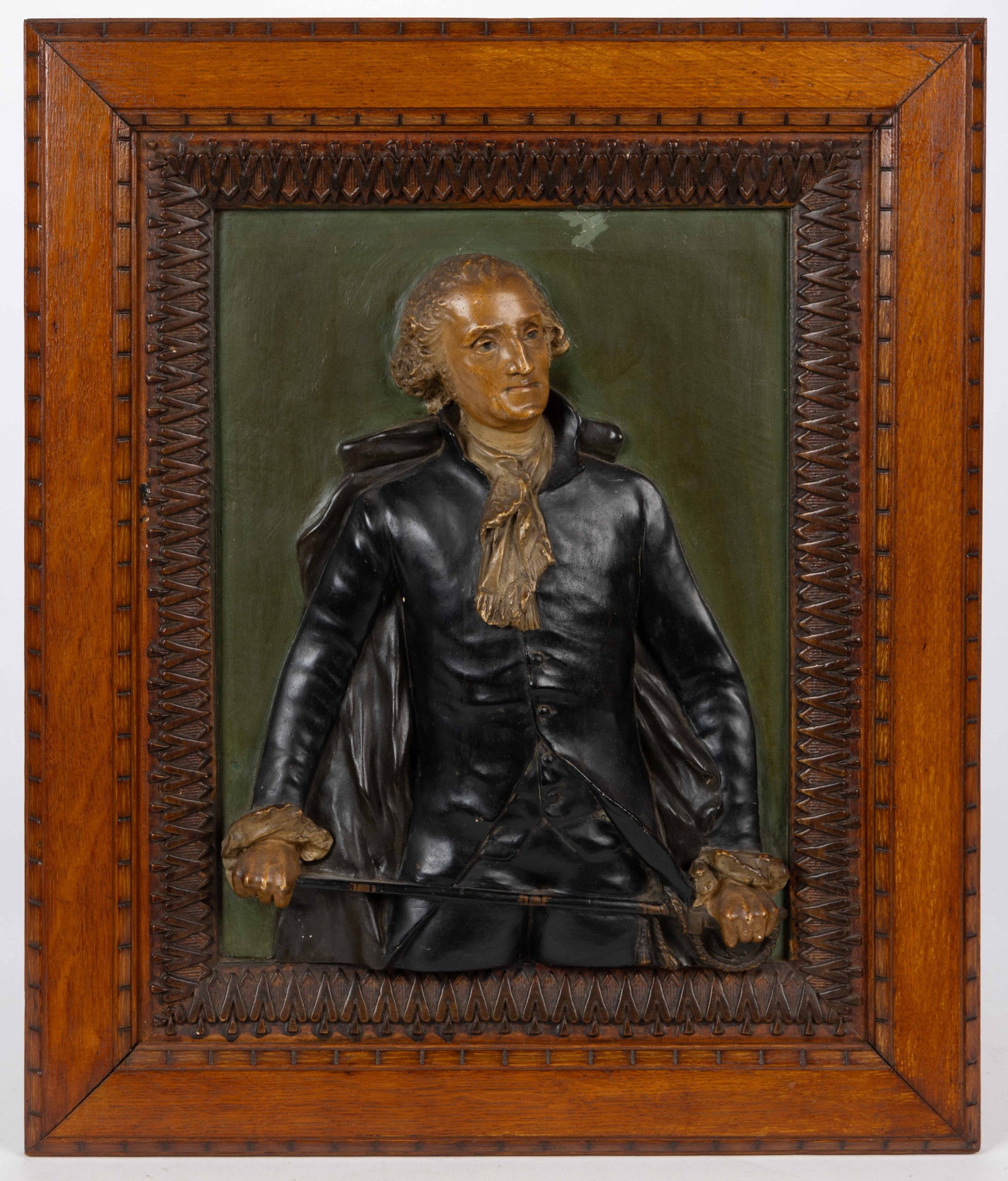 GEORGE WASHINGTON PAINT-DECORATED MOLDED COMPOSITION PLAQUE: GEORGE WASHINGTON PAINT-DECORATED MOLDED COMPOSITION PLAQUE, a three-dimensional three-quarter length depiction of Washington standing with his sword across his body. Housed in the likely origina