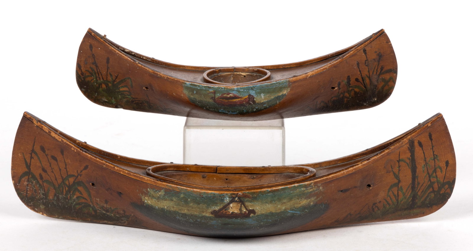 AMERICAN ADIRONDACK-STYLE PAINT-DECORATED FIGURAL HANGING MATCH SAFES, LOT OF TWO: AMERICAN ADIRONDACK-STYLE PAINT-DECORATED FIGURAL HANGING MATCH SAFES, LOT OF TWO, each a half-hull canoe form bearing central nautical vignette flanked by marshy grasses at ends, retaining original s
