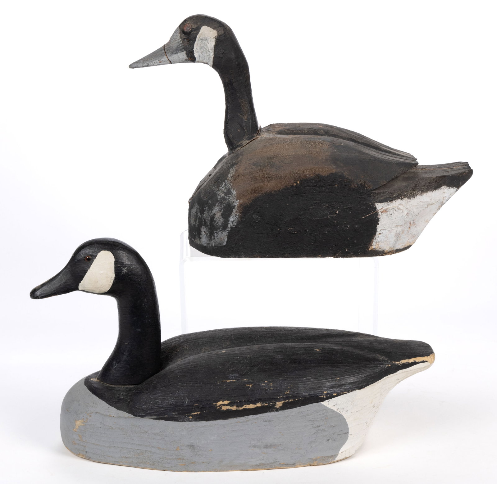 AMERICAN FOLK ART CARVED AND PAINTED WOODEN GOOSE DECOYS, LOT OF TWO: AMERICAN FOLK ART CARVED AND PAINTED WOODEN GOOSE DECOYS, LOT OF TWO, both examples of very similar form, one with deeply-carved details on the body, and inset red eyes; the other with more reali