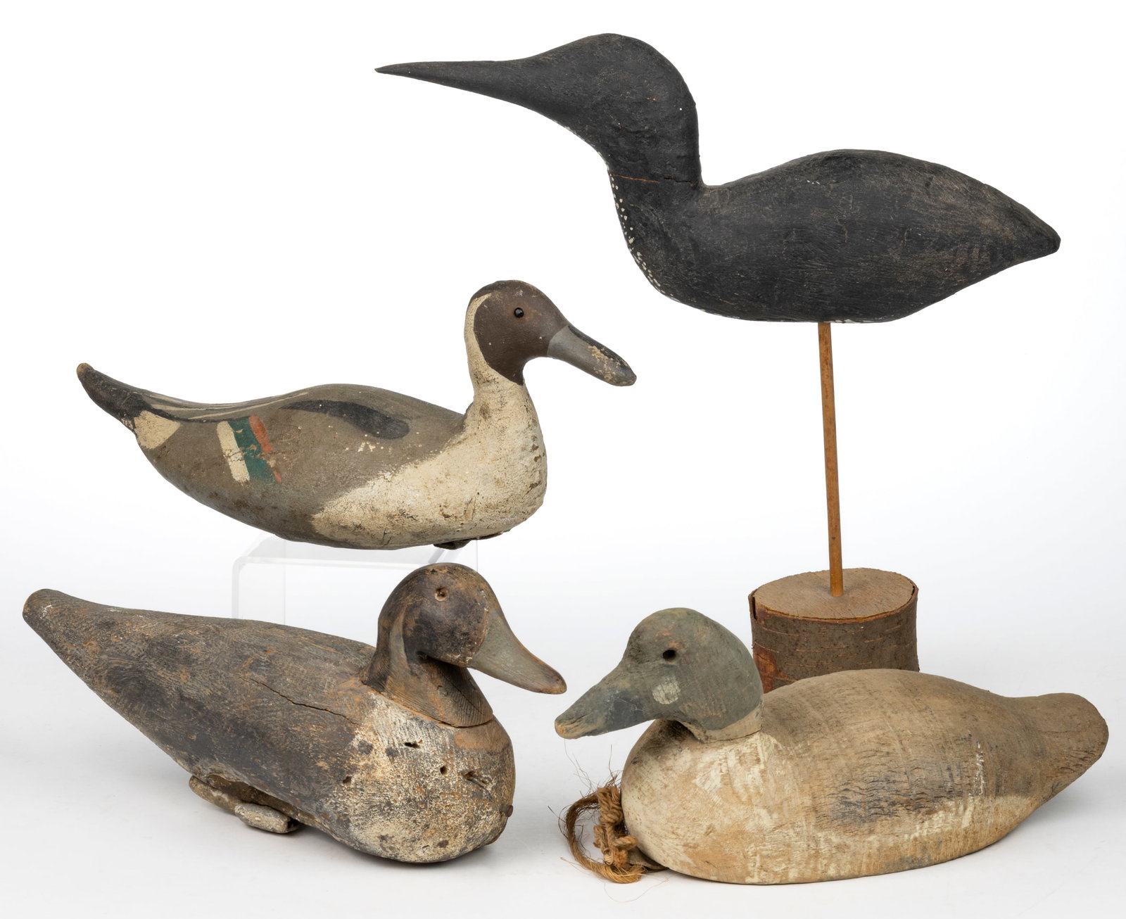 AMERICAN FOLK ART CARVED AND PAINTED DUCK DECOYS, LOT OF FOUR: AMERICAN FOLK ART CARVED AND PAINTED DUCK DECOYS, LOT OF FOUR, two of solid-body form, one of hollow-body form with an open underside, and one constructed from canvas, including various duck species a