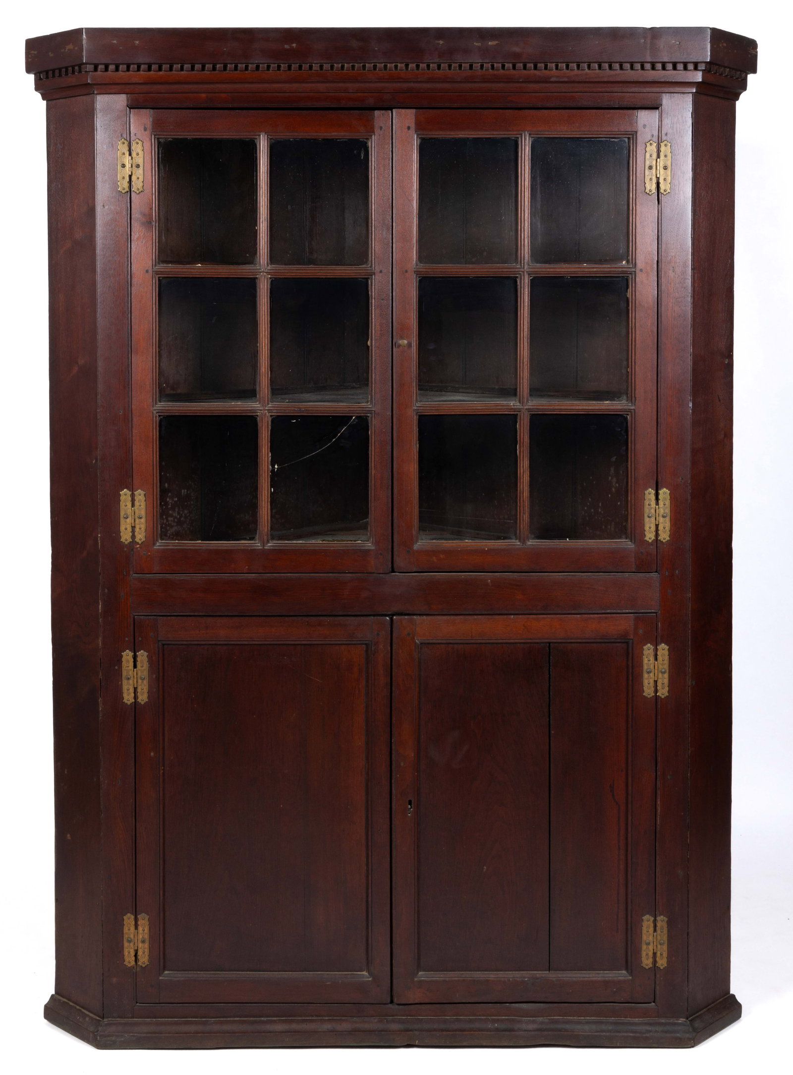 SHENANDOAH VALLEY OF VIRGINIA WALNUT CORNER CUPBOARD: SHENANDOAH VALLEY OF VIRGINIA WALNUT CORNER CUPBOARD, single-piece construction, the applied dental-molded cornice over two six-pane hinged cabinet doors, which retain most of their early wavy gl