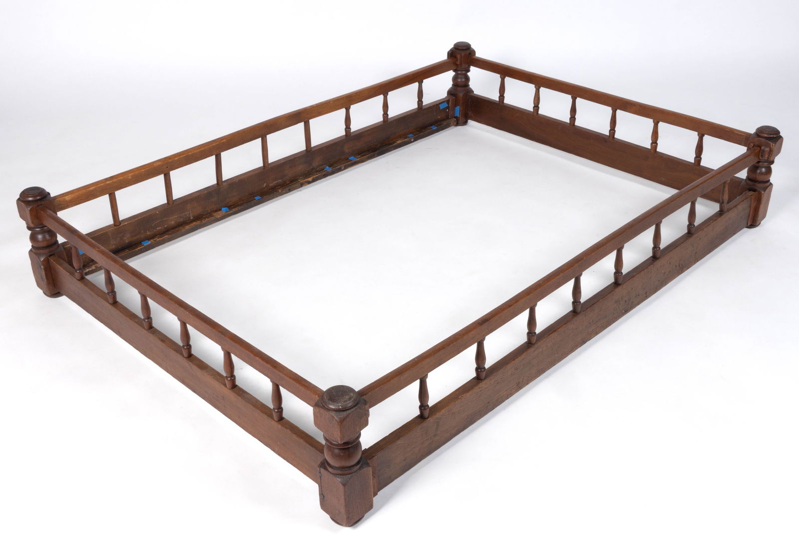 VIRGINIA TURNED WALNUT TRUNDLE ROPE BED: VIRGINIA TURNED WALNUT TRUNDLE ROPE BED, featuring turned corner posts, the rails and headboards in similar form with two rails connected by turned spindles. Retains an old refinished surfac