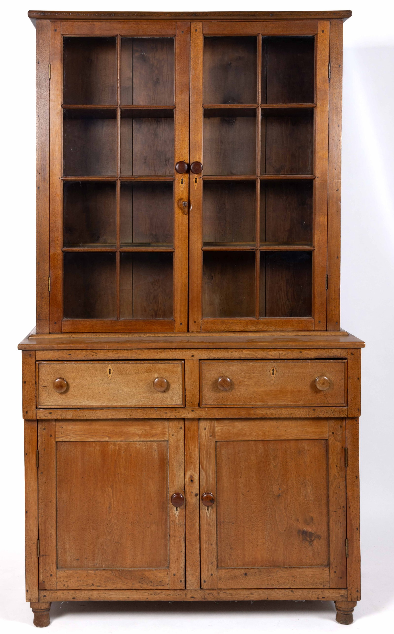 VIRGINIA WALNUT DISH / JACKSON PRESS: VIRGINIA WALNUT DISH / JACKSON PRESS, two-piece construction, the upper case with an applied simple molded edge cornice over two eight-pane glazed cabinet doors, each having a turned wooden knob and i