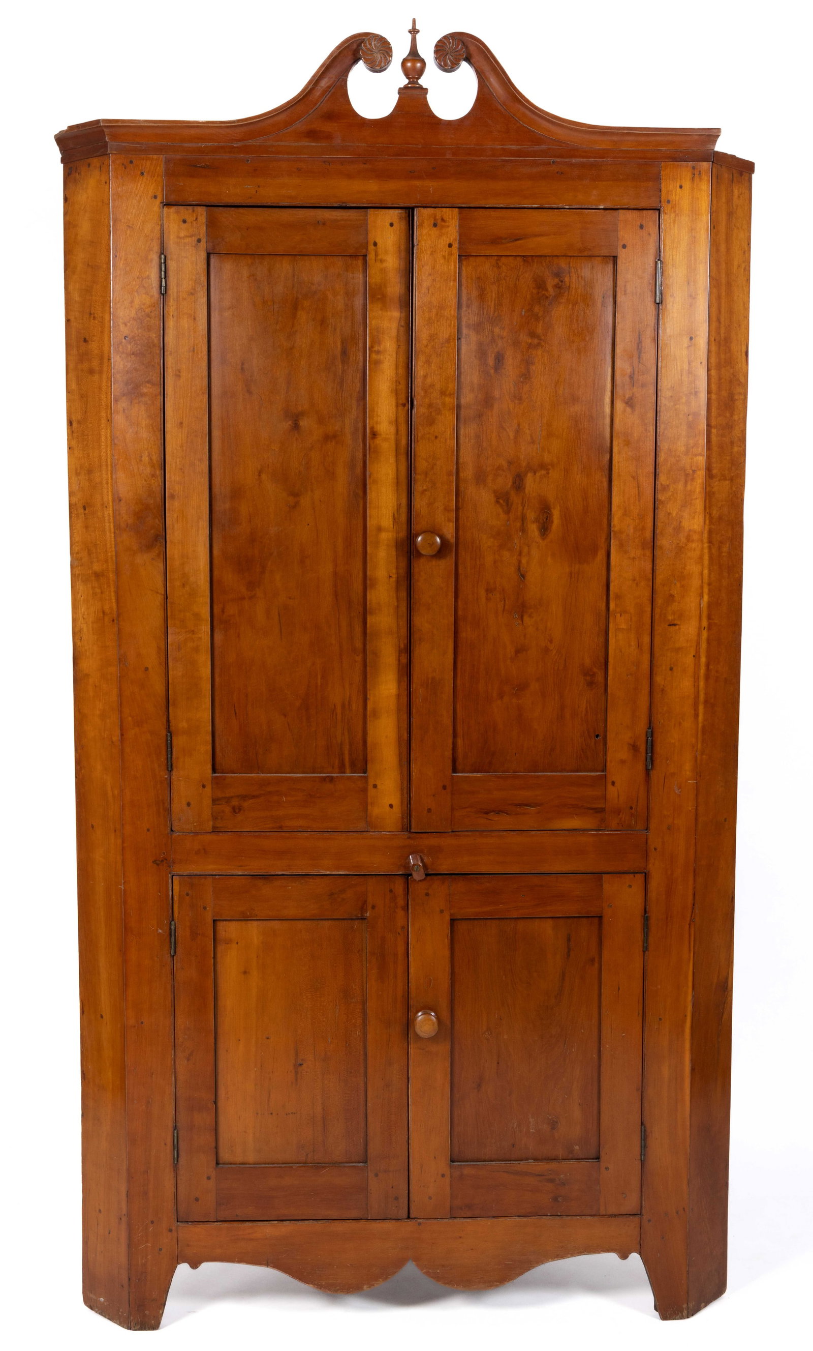 GREEN CO., EAST TENNESSEE, ATTRIBUTED, FEDERAL CHERRY CORNER CUPBOARD: GREEN CO., EAST TENNESSEE, ATTRIBUTED, FEDERAL CHERRY CORNER CUPBOARD, single-piece construction, the broken arch crest featuring spiral-carved rosettes flanking a turned finial above two pairs o