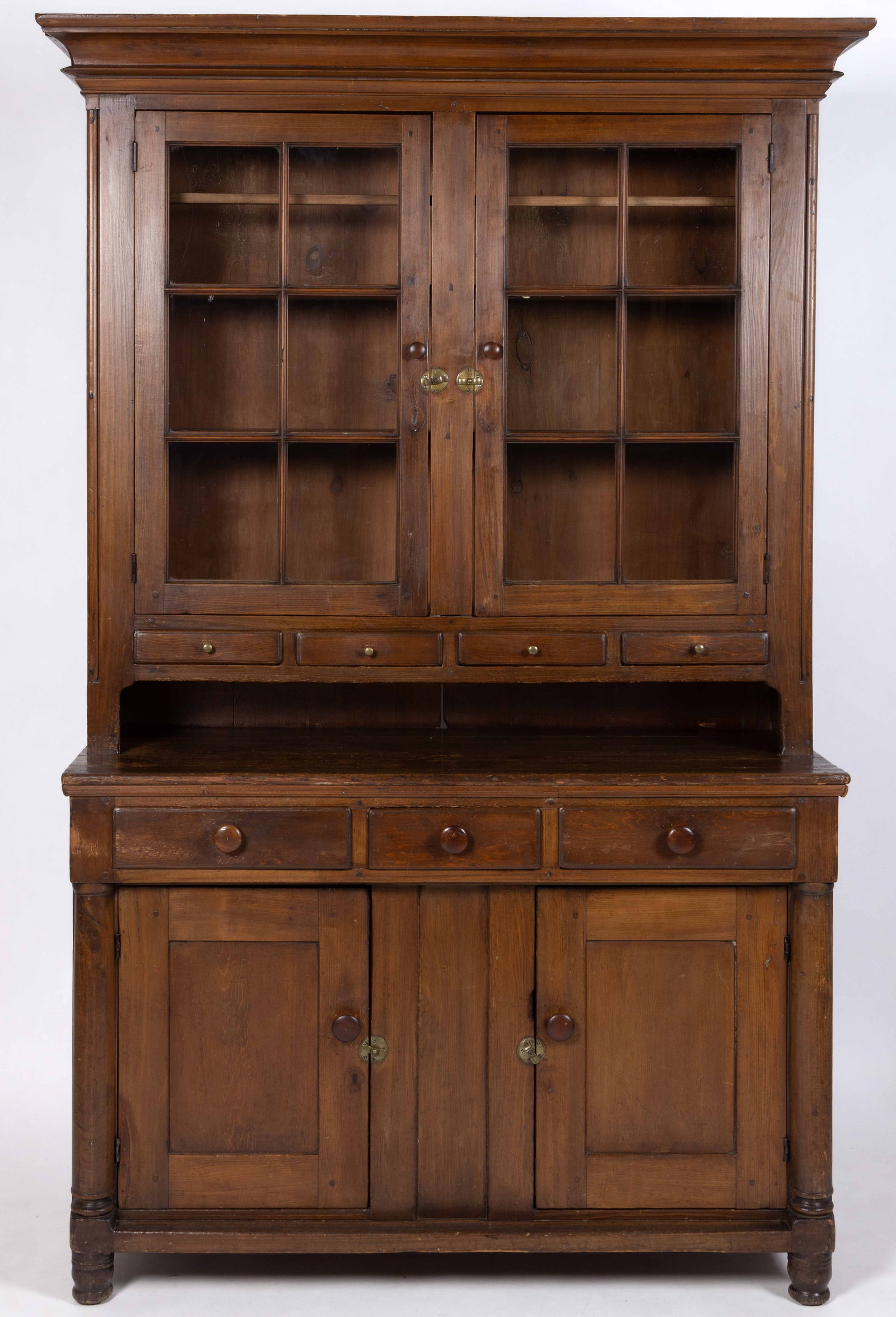 PENNSYLVANIA POPLAR AND PINE STEP-BACK DUTCH CUPBOARD: PENNSYLVANIA POPLAR AND PINE STEP-BACK DUTCH CUPBOARD, two-piece construction, upper case with applied cove-molded cornice over two six-light doors, three fixed interior shelves, one with spoon slots 