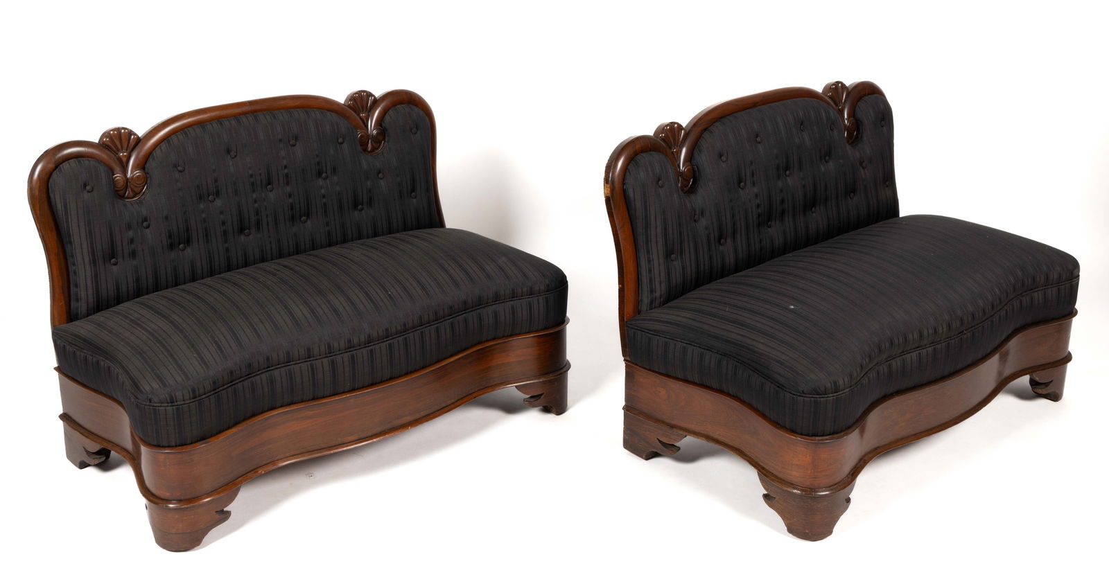 PAIR OF AMERICAN CLASSICAL ROSEWOOD-VENEERED SETTEES: PAIR OF AMERICAN CLASSICAL ROSEWOOD-VENEERED SETTEES, each with a shaped back with shell carved elements over a shaped seat, the whole supported by a bracket foot base which follows the contour of the