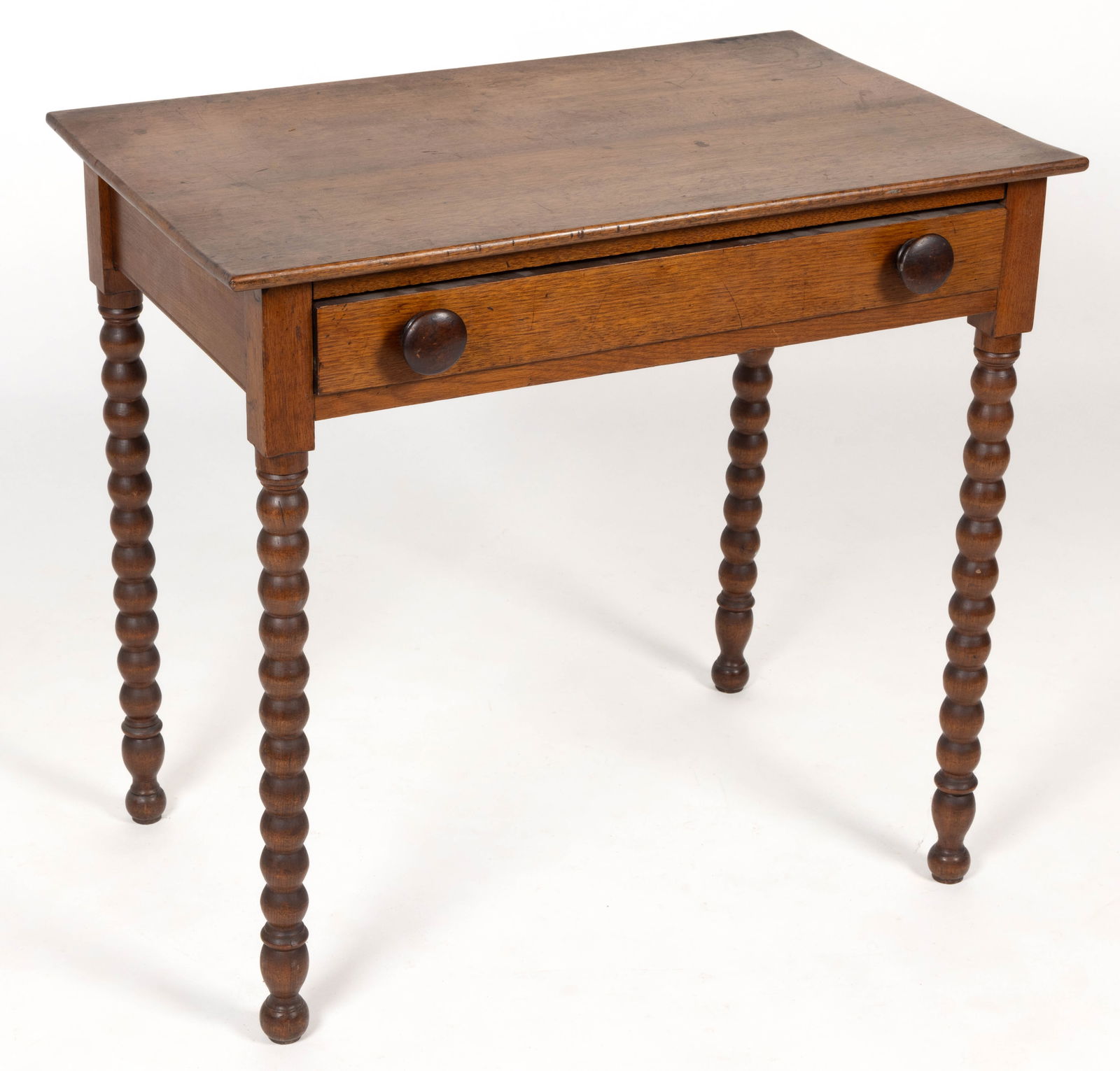 AMERICAN LATE FEDERAL WALNUT STAND TABLE: AMERICAN LATE FEDERAL WALNUT STAND TABLE, the rectangular top over a single full drawer with two turned wooden knobs, the whole raised on spool-like turned legs. The underside of the drawer retains a