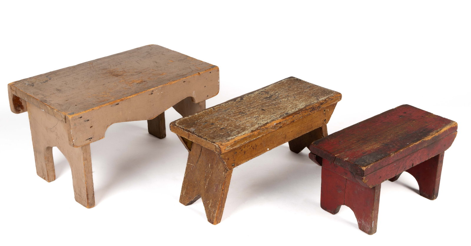 AMERICAN COUNTRY PAINTED WOODEN FOOT STOOLS, LOT OF THREE: AMERICAN COUNTRY PAINTED WOODEN FOOT STOOLS, LOT OF THREE, each of similar form with a rectangular top with two battens applied to the sides or under the edge, each supported on cut-out legs. Each ret