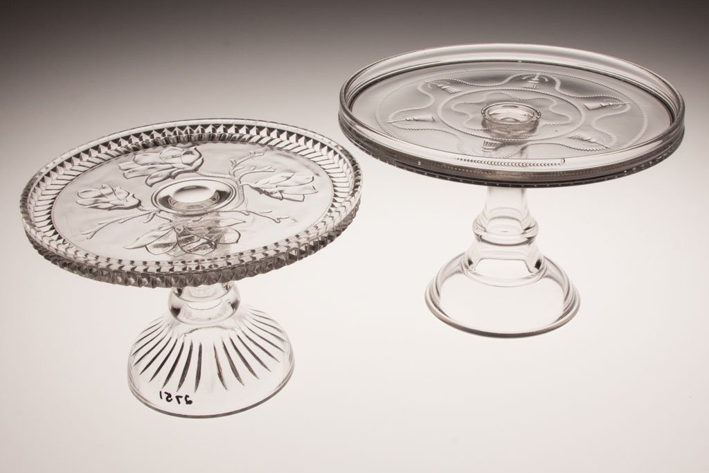 VARIOUS EAPG CAKE STANDS, LOT OF TWO: VARIOUS EAPG CAKE STANDS, LOT OF TWO, colorless, comprising Magnolia and Cord and Tassel. Fourth quarter 19th century. 9 1/2" and 10 1/2" D.