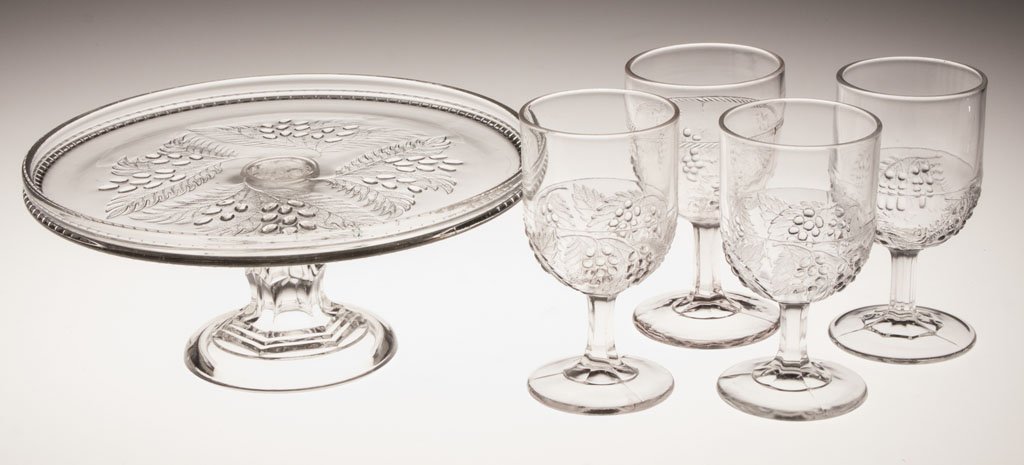 VARIOUS EAPG TABLE ARTICLES, LOT OF FIVE: VARIOUS EAPG TABLE ARTICLES, LOT OF FIVE, colorless, comprising a Barberry cake stand, four Barberry goblets and a Currant goblet. Fourth quarter 19th century. 4 3/4" to 6" H. Provenance: Collection o