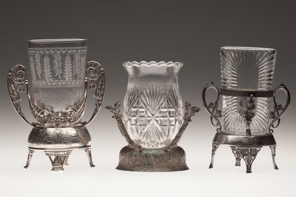 VARIOUS GLASS CELERY VASES, LOT OF THREE: VARIOUS GLASS CELERY VASES, LOT OF THREE, colorless, each fitted in a silver-plated frame, including Majestic. Fourth quarter 19th century. 7" to 8 3/8" HOA. Provenance: The Helen M. Collins collectio