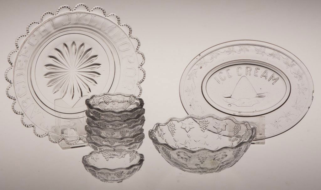 VARIOUS CHILDREN'S GLASS TABLE ARTICLES, LOT OF NI: VARIOUS CHILDREN'S GLASS TABLE ARTICLES, LOT OF NINE, colorless, including seven-piece Nursery Rhyme berry set, Ice Cream master dish. Early 20th century. 2 1/2" to 6 1/4" D rim, 4 1/2" x 5 3/4" rim.