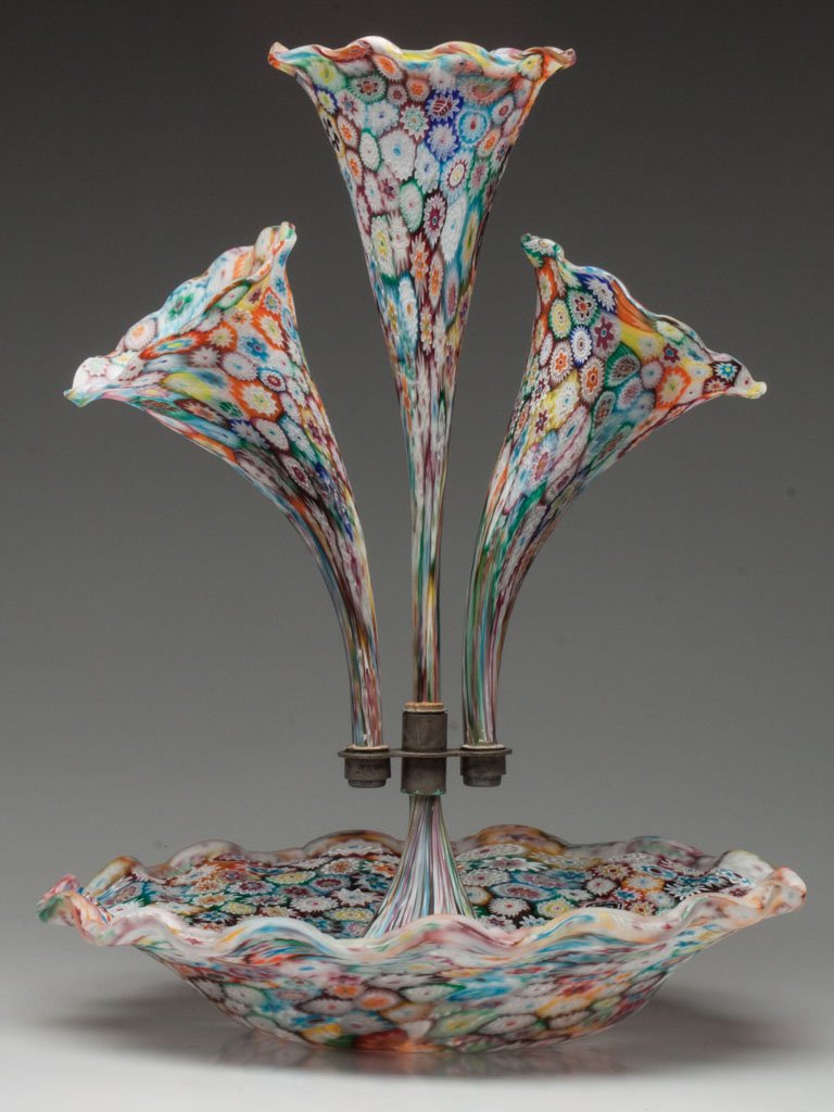ITALIAN MILLEFIORI EPERGNE: ITALIAN MILLEFIORI EPERGNE, ruffled-rim bowl surmounted with three trumpet-form vases secured in a metal mount. Murano area of Italy. Mid 20th century. 15 1/2" HOA, 12" DOA. Provenance: From the colle