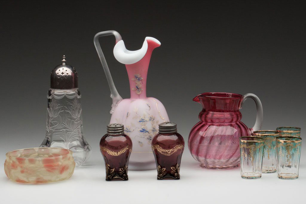 ASSORTED GLASS ARTICLES, LOT OF TEN: ASSORTED GLASS ARTICLES, LOT OF TEN, including a colorless English engraved muffineer, a vaseline spatter Leaf Mold sauce dish, and four green to colorless Moser-type shot glasses. Fourth quarter 19th