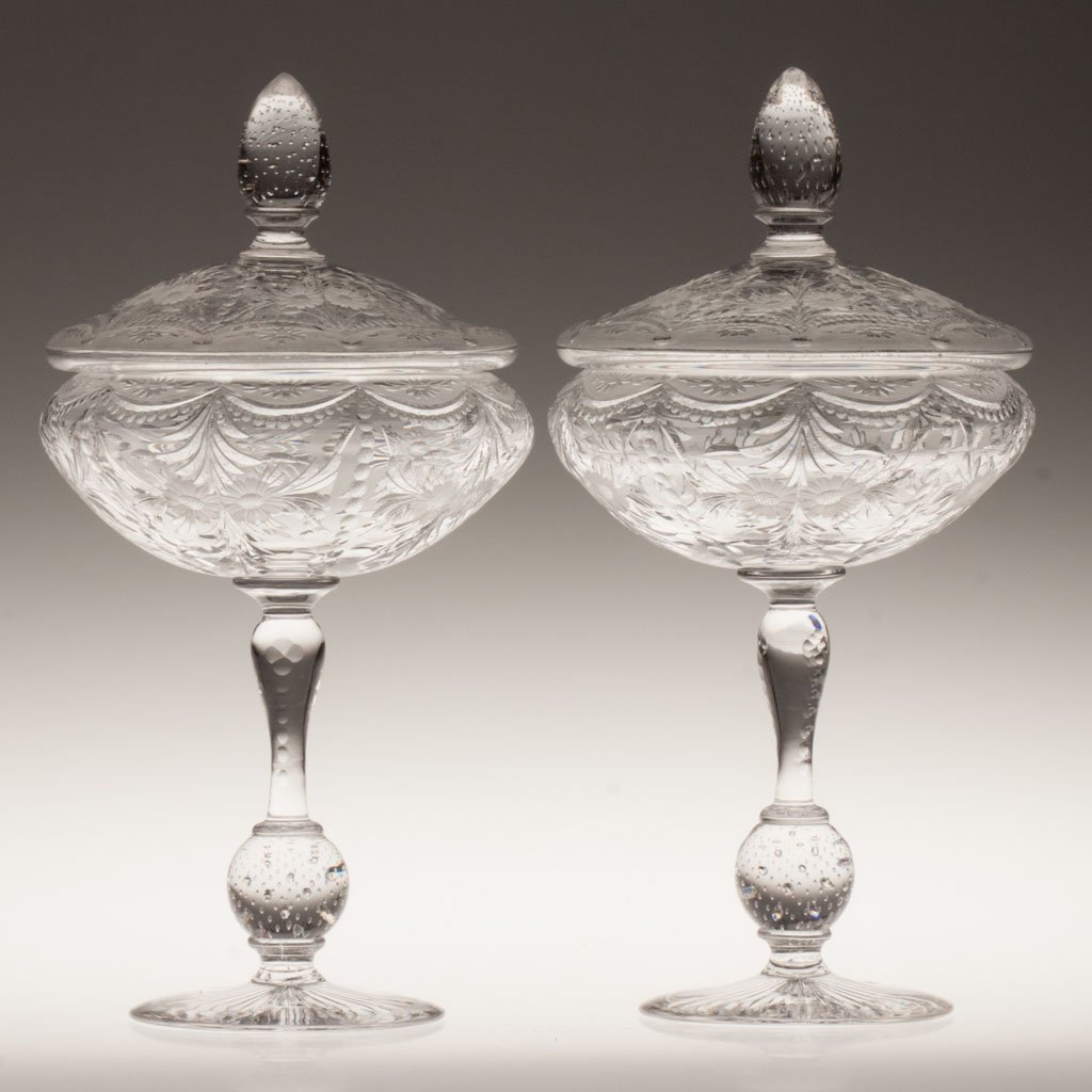 PAIRPOINT WICKHAM PATTERN PAIR OF COVERED COMPOTES: PAIRPOINT WICKHAM PATTERN PAIR OF COVERED COMPOTES, colorless, each with bubble-ball stem and cover finial, rayed base. Pairpoint Glass Co. First quarter 20th century. 12" HOA, 6 1/8" W. Literature: F