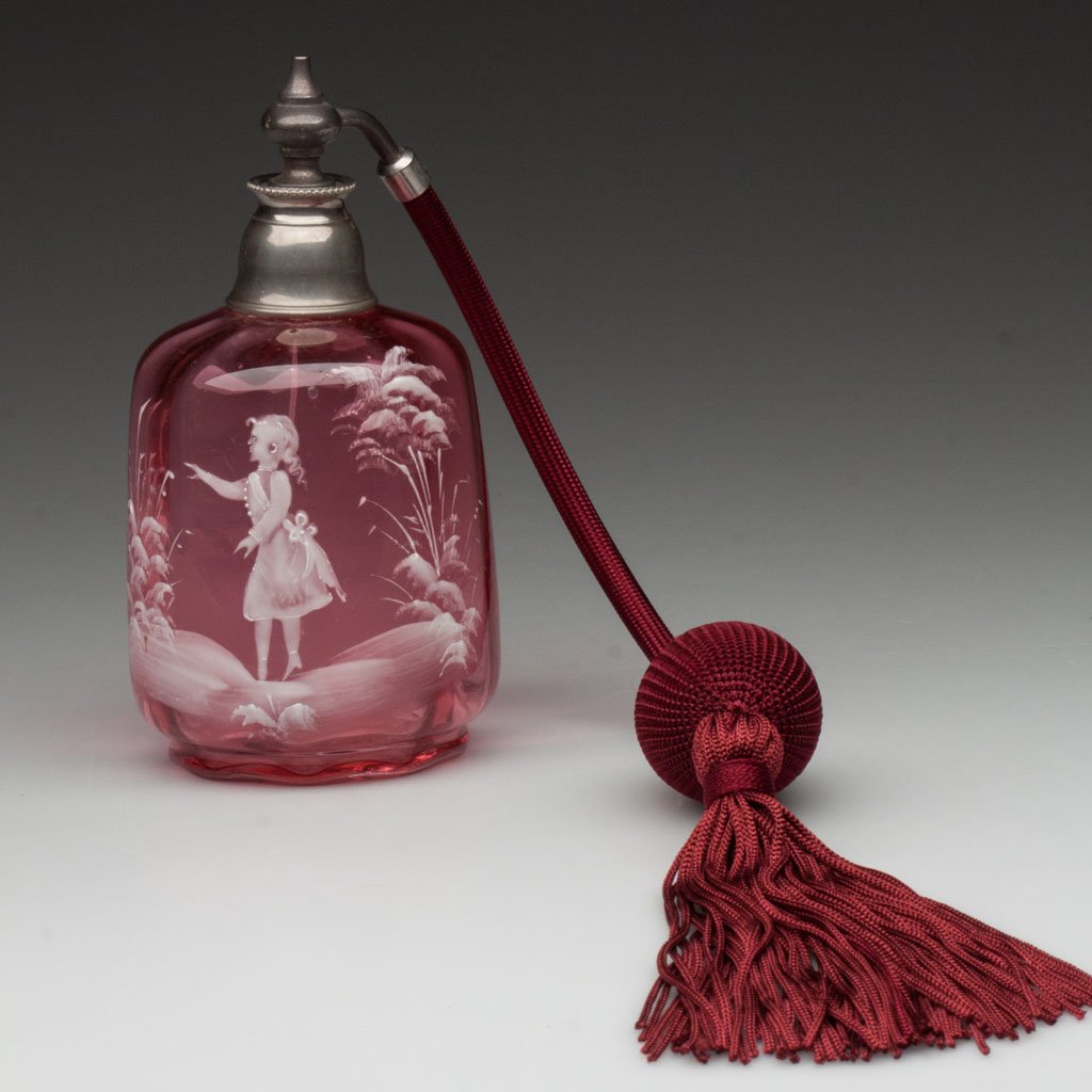 MARY GREGORY (SO CALLED) ATOMIZER: MARY GREGORY (SO CALLED) ATOMIZER, cranberry, panel optic, white enamel decoration featuring a young girl, metal mount, replaced fabric and bulb. Late 19th/early 20th century. 5" H. Provenance: The co