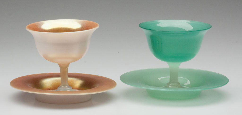 STEUBEN ART GLASS SHERBET AND UNDERTRAY SETS, LOT: STEUBEN ART GLASS SHERBET AND UNDERTRAY SETS, LOT OF TWO, shape 2680, comprising a Gold Calcite and a Green Jade and Alabaster, Jade under tray stamped with acid fleur-de-lis mark. Steuben Glass Works
