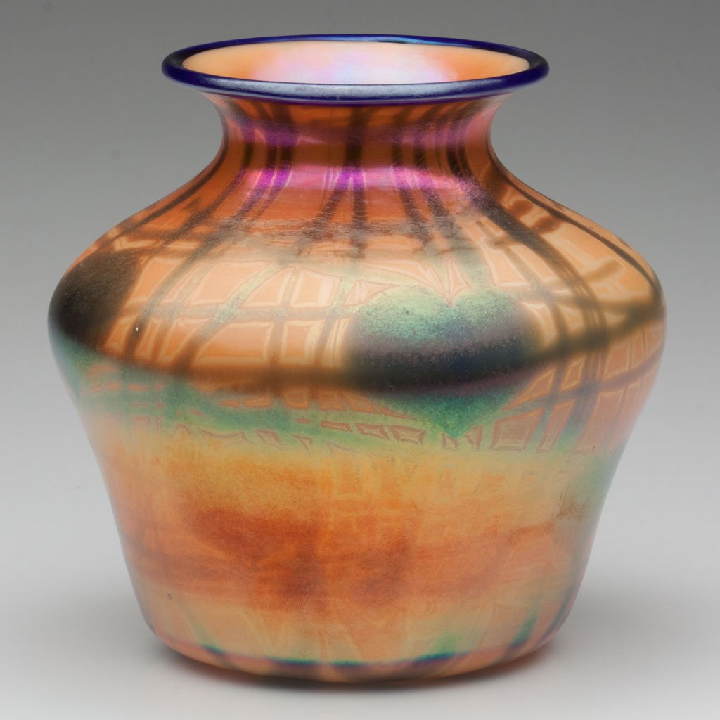 IMPERIAL DECORATED FREE HAND VASE: IMPERIAL DECORATED FREE HAND VASE, iridescent orange with blue hanging hearts, blue rim, catalogue number FH 276, polished pontil mark with original gold-foil label. Imperial Glass Co. Circa 1925. 6" 