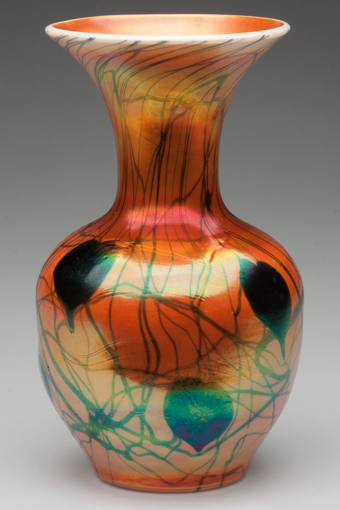 IMPERIAL DECORATED LEAD LUSTRE VASE: IMPERIAL DECORATED LEAD LUSTRE VASE, iridescent orange with blue hanging hearts, orange interior, shape 415, polished pontil mark. Imperial Glass Co. Circa 1925. 10" H. Literature: Parallels Measell -