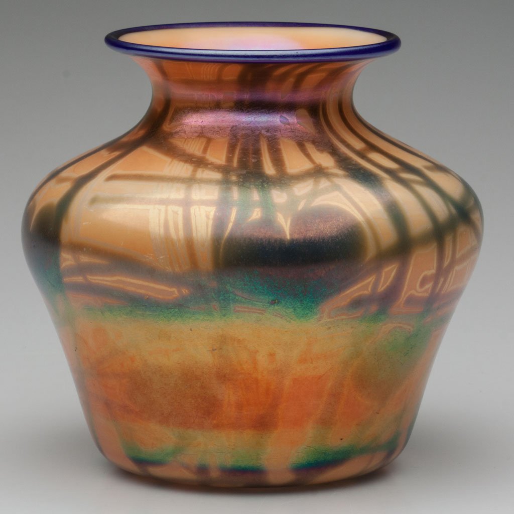 IMPERIAL DECORATED FREE HAND VASE: IMPERIAL DECORATED FREE HAND VASE, iridescent orange with blue hanging hearts, blue rim, catalogue number FH 276, polished pontil mark. Imperial Glass Co. Circa 1925. 6" H. Literature: Measell - Imper