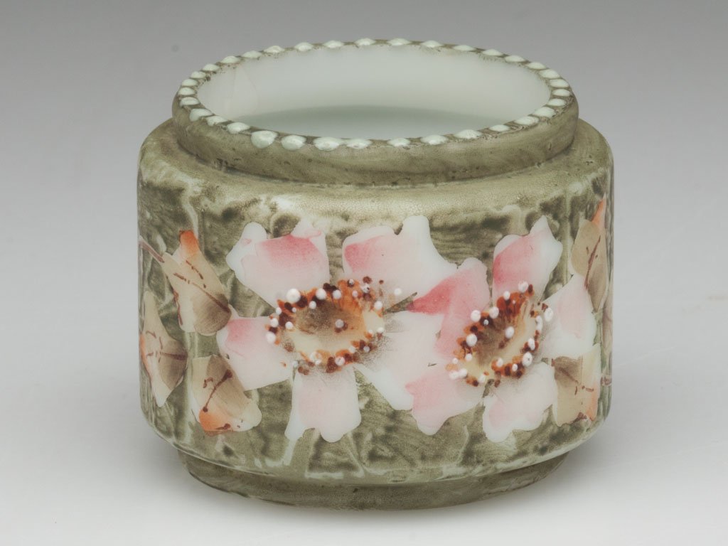 C. F. MONROE KELVA TOOTHPICK HOLDER: C. F. MONROE KELVA TOOTHPICK HOLDER, green ground with polychrome floral decoration, tiny beading to the top of rim. C. F. Monroe Glass Co. Fourth quarter 19th century. 1 5/8" H. Literature: Parallels