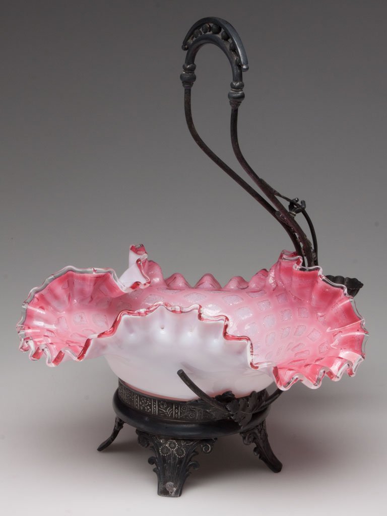 VICTORIAN AIR-TRAP BRIDE'S BASKET: VICTORIAN AIR-TRAP BRIDE'S BASKET, glossy cased rose to pink with colorless rim, diamond air-traps and polished pontil mark, fitted in a quadruple-plate frame marked for James W. Tufts and numbered 15