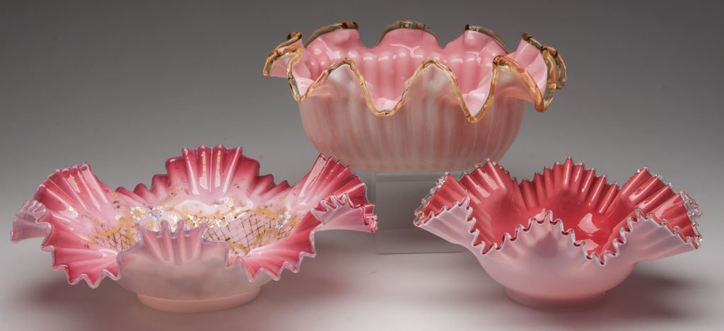 VICTORIAN CASED GLASS BRIDE'S BOWLS, LOT OF THREE: VICTORIAN CASED GLASS BRIDE'S BOWLS, LOT OF THREE, various shades of rose, large example with polychrome enamel decoration, oval example with an applied amber rim, ground and polished pontil marks. Fo