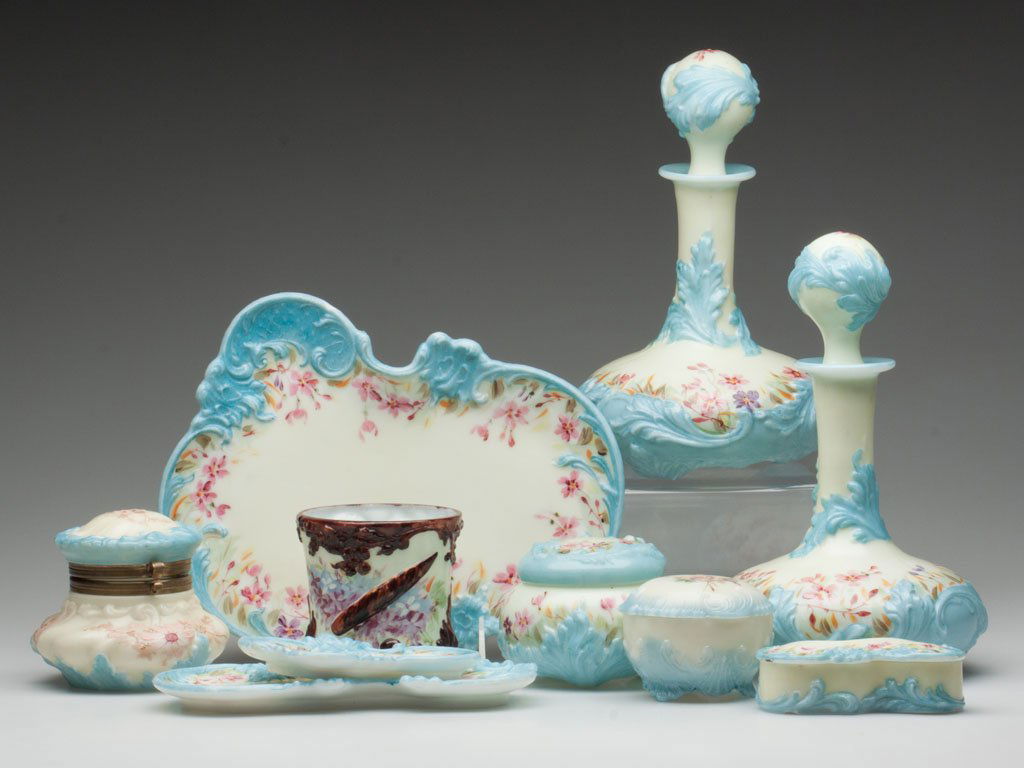 H. M. RIO & CO "KEYSTONE WARE" DRESSER AND SMOKING: H. M. RIO & CO "KEYSTONE WARE" DRESSER AND SMOKING ARTICLES, LOT OF TEN, opaque white with blue stain and polychrome floral decoration, various rococo molded patterns, each marked on base "H. M. R. &
