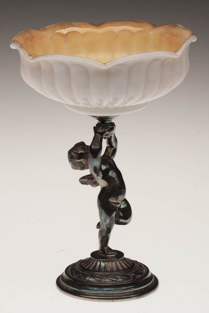 NEW MARTINSVILLE OPAL MURANESE BOWL: NEW MARTINSVILLE OPAL MURANESE BOWL, scalloped rim with light iridescence to rim, fitted in a Pairpoint No. 4970 figural silver-plated frame depicting a cherub, weighted base. New Martinsville Glass C