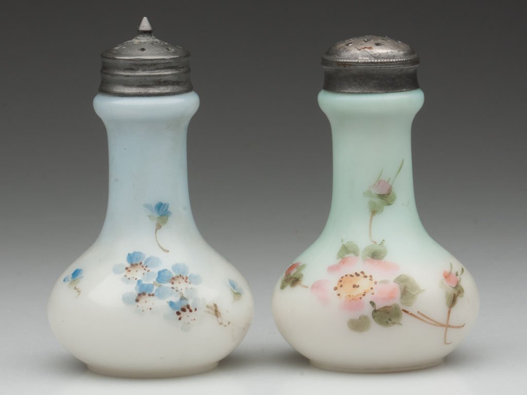 BELLE WARE SALT AND PEPPER SHAKERS, LOT OF TWO: BELLE WARE SALT AND PEPPER SHAKERS, LOT OF TWO, opal with a pale blue ground and other with a green ground, each with floral polychrome decoration, waisted form, non-matching period lids, bases emboss