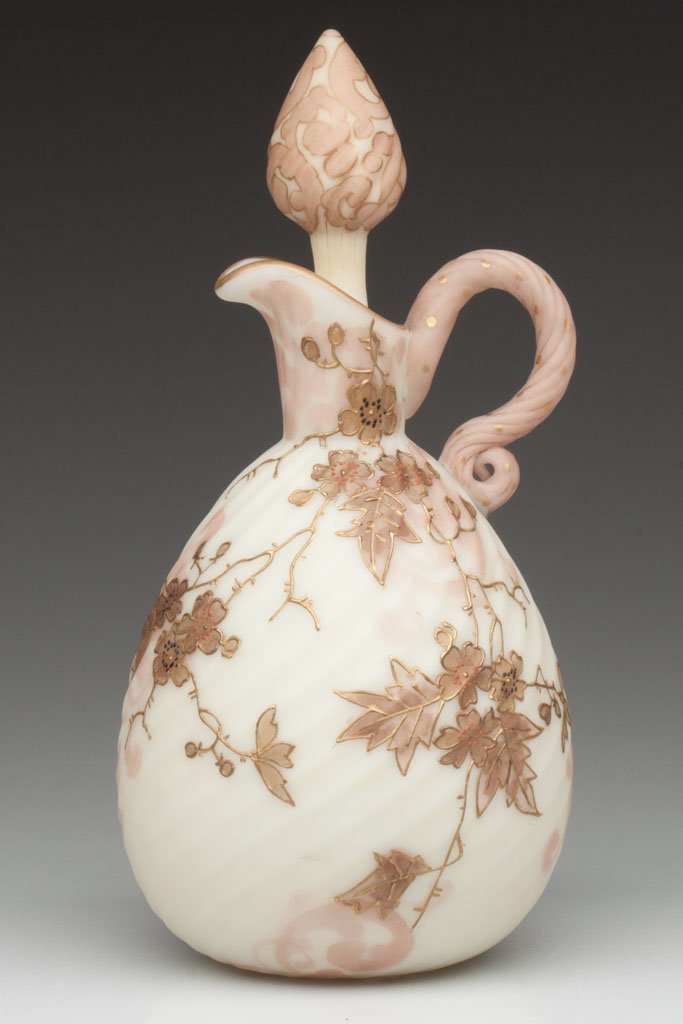 MT. WASHINGTON CROWN MILANO SWIRL CRUET: MT. WASHINGTON CROWN MILANO SWIRL CRUET, opal with cream ground, light pink staining and gilt decoration, matching decorated applied reeded handle and stopper, polished pontil mark. Mt. Washington Gla